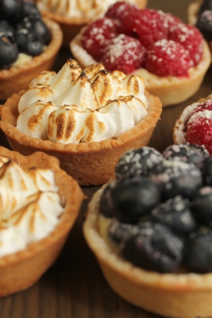 Lemon tarts and fruity tarts on a displayの写真素材