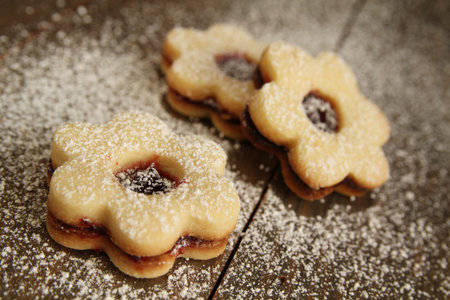 Flowers shape cookies cover with powder sugar on a wooden table