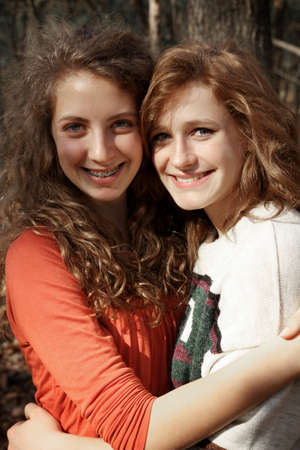 Two girls best friends in a forest during autumnの写真素材