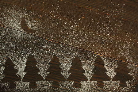 Christmas tree empty space made with sugar powder with a sugar moon shapeの写真素材