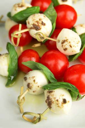 Top view of delicious skewer with boccocini, cherry tomatoes and basil or capreseの写真素材