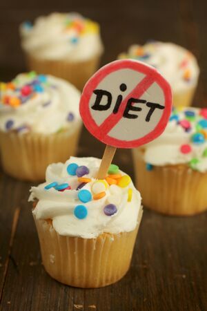 Cupcakes with colorful sprinkles and no diet signの写真素材