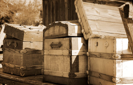 Three old chest in a carriage in sepia