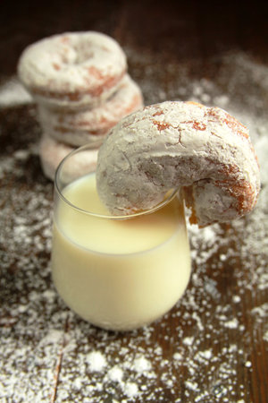 Ice sugar powdered donut in a glass of milkの写真素材