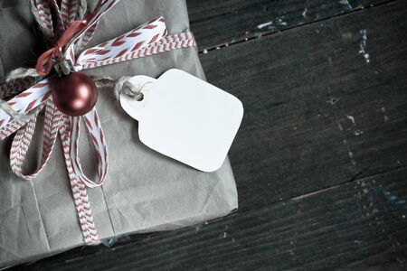 VIntage gift wrap with tag name and bow on a wooden の写真素材