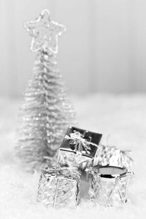 Silver gifts and a christmas tree with a star on top の写真素材