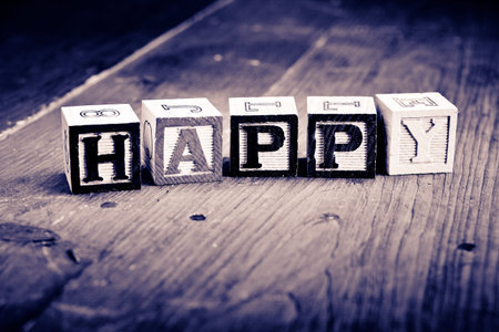alphabet wood blocks forming the word happy   Vintage process 