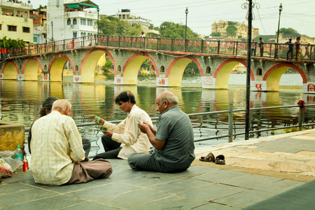 UDAIPUR - SEPT 20 2012:  Four man playing cards on the side of the Pichola lake at Udaipur also...