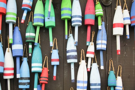 Colorful buoys on a wall of a shake in Maine, USAの写真素材