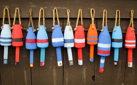 Colorful buoys on a wall of a shake in Maine, USAの写真素材