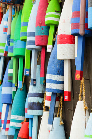 Colorful buoys on a wall of a shake in Maine, USAの写真素材
