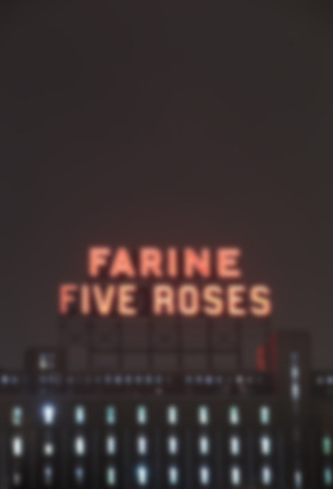 MONTREAL CANADA JANUARY 25 2015: Icon of the industrial heritage of Montreal, neon "Farine five roses" blurred and illuminated Montreal since 1948.のeditorial素材