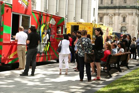 MONTREAL, CANADA - JULY 23, 2015: People waiting for their lunch at food trucks into the business area in Montreal, Quebec on july 23.のeditorial素材