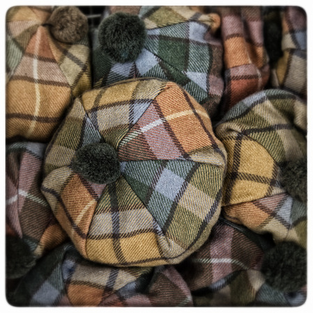 Yellow, orange and blue Scottish tartan hats.の写真素材