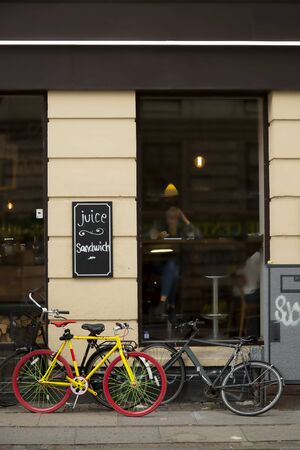 Yellow bicycle in front of a restaurant in Copenhagenのeditorial素材
