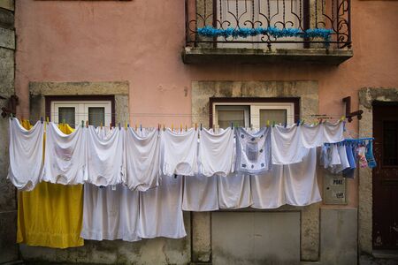White clothes on a clothesline in Alfama, Lisbonの写真素材