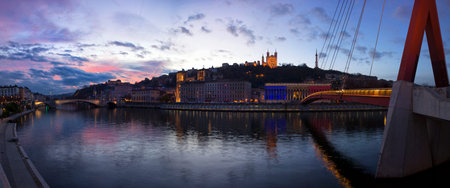 VIew basilica the fourviere and the passerelle du palais de justice over the soane at sunset at...
