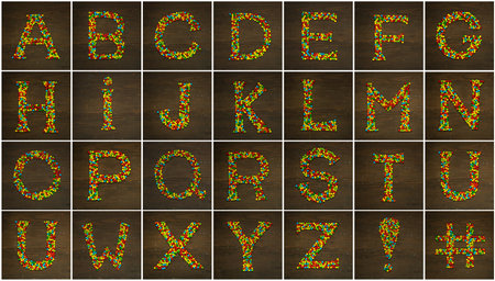 Letter A to Z made with star shape candies on a wooden background making the alphabet