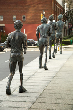 VANCOUVER-CANADA, 18 february 2016:  Four bronze statues of Terry Fox depict the iconic hopping and shuffling gait Fox adopted as he attempted to run across Canada in 1980 on an artificial leg to raise money for cancer researchのeditorial素材