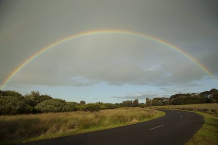 Full rainbow over an australian landscape at Philip island in Australiaの写真素材