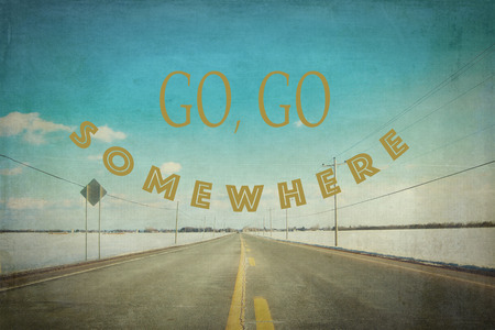Inspirational quote go, go somewhere on picture of a desert road during winter season in Canadaの写真素材
