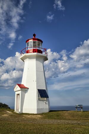 The red and white Cap Gaspe lighthouse in Gaspesie, Quebec, Canada during summer seasonの写真素材