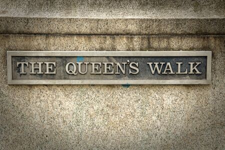 The queen's walk sign in London.  Queen's Walk takes you over Westminster Bridge, along the south bank of the River Thames towards over the river on the Millennium footbridge to St Paul's Cathedralのeditorial素材