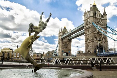 LONDON, UK - JUNE 7 , 2017: Girl With A Dolphin Fountain" by English artist David Wynne in front of the tower bridge in London, UKのeditorial素材