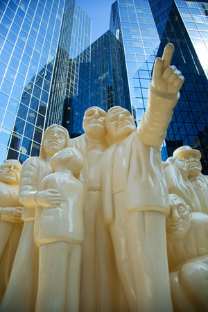 MONTREAL, CANADA - SEPTEMBER 14, 2017:  The Illuminated Crowd created by Raymond Mason is a sculpture consisting of 65 people of all ages, race, facial expressions and conditions, depicted on four platforms and illustrates the degradation of the human racのeditorial素材