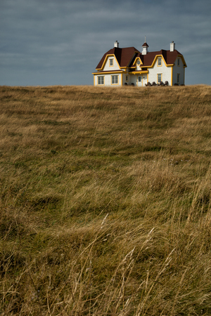 Beautiful white house on the top of the hillの写真素材