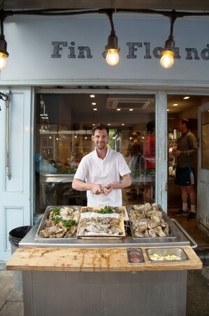 LONDON-UK June 9, 2017:   Man opening fresh oyster at his place in Londonのeditorial素材