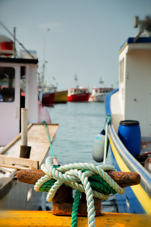 Close up of mooring ropes tightly attach to the harbourの写真素材