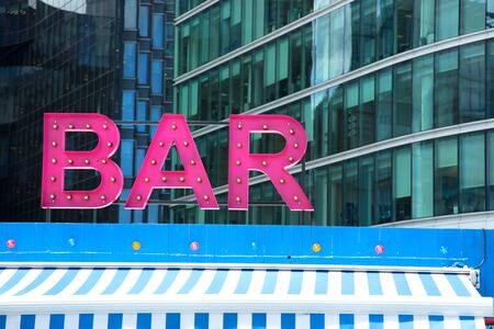 Pink retro styled bar sign in London, UK.のeditorial素材