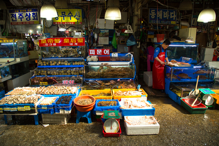 SEOUL-SOUTH KOREA, MAY 18, 2018: Man at his booth at the fish market in south Korea. Noryangjin Fish Market is an extensive farmers market in Noryangjin-dongのeditorial素材