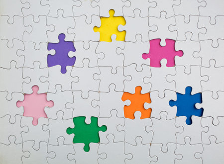 Missing few white  puzzle pieces on the rainbow colours background