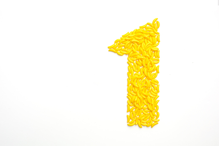 Number one made with banana candies on a white backgroundの写真素材