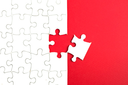 Missing a white puzzle piece on a blue backgroundの写真素材