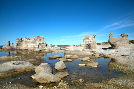 Le chateau and agneau monolithe at grande ile in Mingan Archipelago National Park Reserve in Quebec in Canadaの写真素材