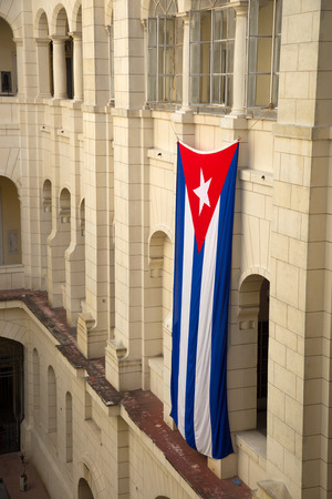 Cuban flag against a building baroque in Havana in Cubaの写真素材