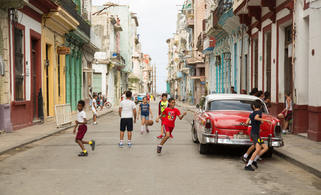 HAVANA-CUBA- DEC 5, 2018: Kids playing ball in the street in Centro Habana, one of the 15 municipalities or boroughs in the city of Havana, Cuba.のeditorial素材