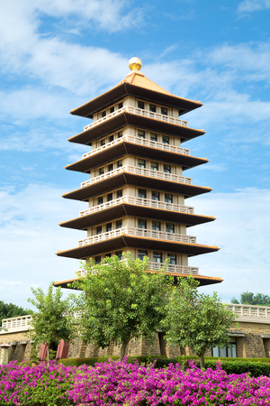 Pagodas in a blue sky with purple flowersのeditorial素材