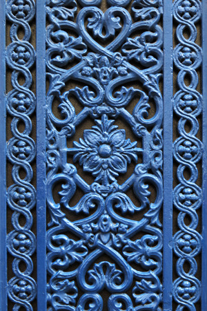 Parisian decorative metal door window in blue colour with a flower in the middleの写真素材