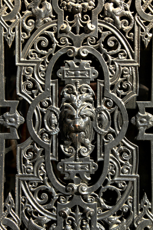 Parisian decorative metal door window in black colour with a lion face in the middleの写真素材