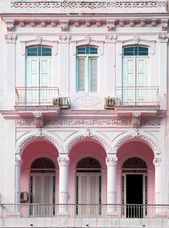 Neoclassical architecture with column in pale rose with white door and pillars in Vedado Havana in Cubaのeditorial素材