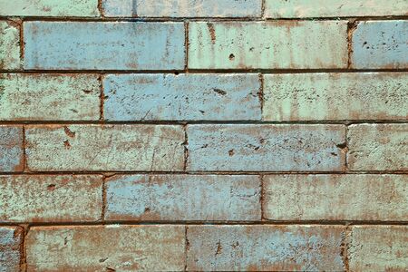 Mat brick wall paint in pastel green and pale blueの写真素材