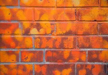 Mat brick wall paint in different orange tonesの写真素材
