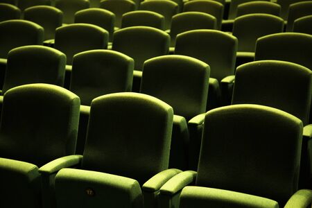 Side view of a green velvet seat in a theatre or a cinemaの写真素材