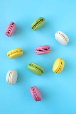 Top view of colorful french traditional macarons on blue backgroundの写真素材