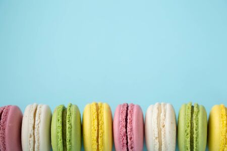 Row of traditional french macarons on blue backgroundの写真素材