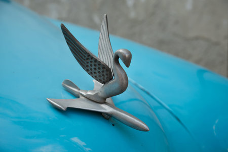 HAVANA-CUBA - December 6, 2019: Chrome Swan Vintage Packard Hood Ornament Antique Cars on a blue car...